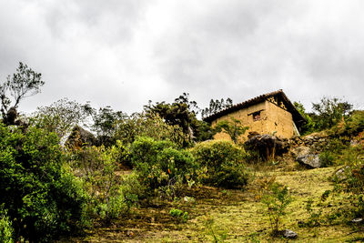 Low angle view of building against cloudy sky