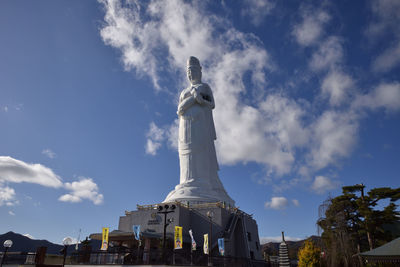 Low angle view of statue against cloudy sky