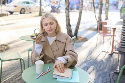 Portrait of young woman using mobile phone