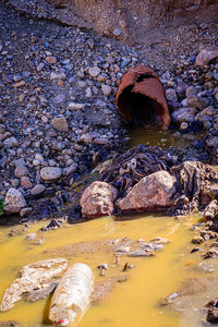 Stone wall with wet rocks in water