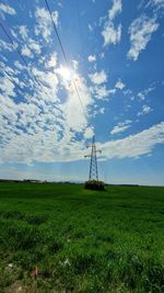 Windmills on field against sky