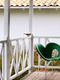 Empty chairs and table against building