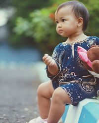 Portrait of cute baby boy standing on field