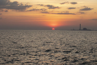 Scenic view of sea against orange sky