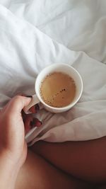 Cropped hand of woman holding coffee