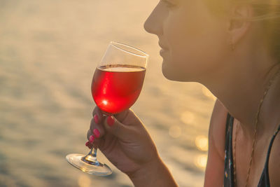 Close-up of woman holding wineglass