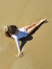 Full length of young woman on sand