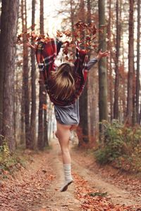 Full length rear view of boy in forest