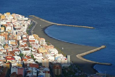 High angle view of townscape by sea