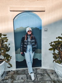 Full length of woman standing by door