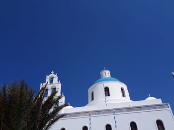 Low angle view of building against clear blue sky