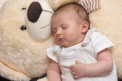 High angle view of baby sleeping on bed