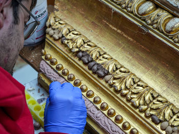 Cropped hand of woman standing in temple