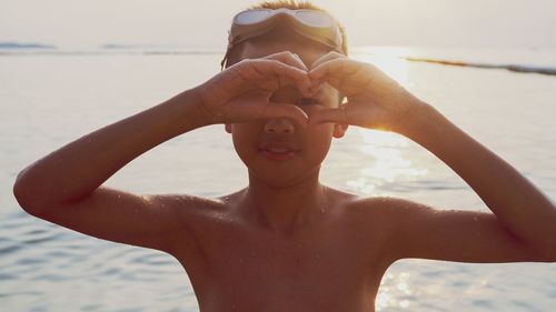 Portrait of shirtless man at beach