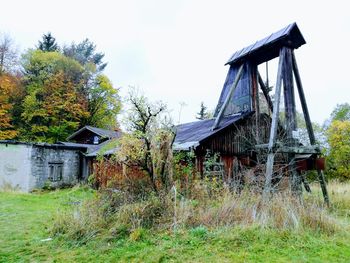 Abandoned house on field against sky