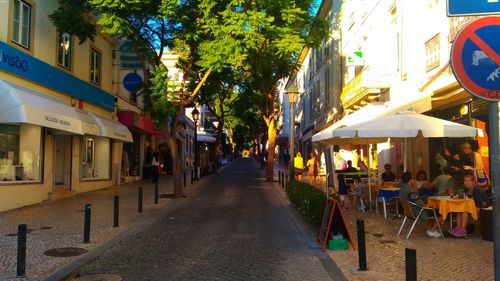 View of empty road along buildings