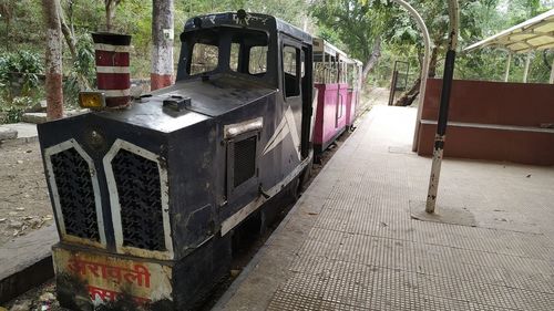 Train on street amidst trees