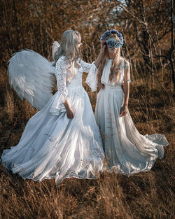 Young women wearing costume standing on field