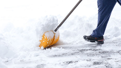 Low section of man skiing on snow