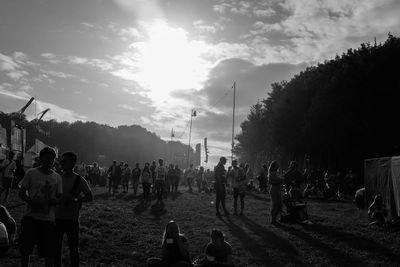 People standing on street against sky