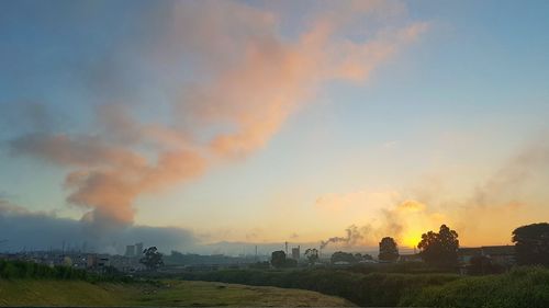 Scenic view of field against sky during sunset