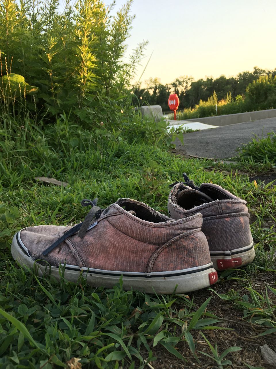 ABANDONED SHOES ON FIELD