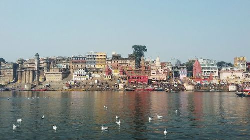 View of buildings in city against clear sky