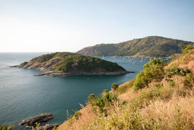 Scenic view of sea and mountains against clear sky