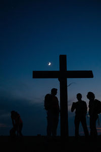 Silhouette people against clear sky at dusk
