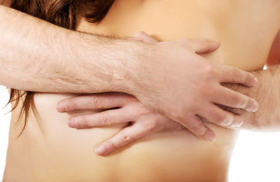 Close-up of hands touching baby