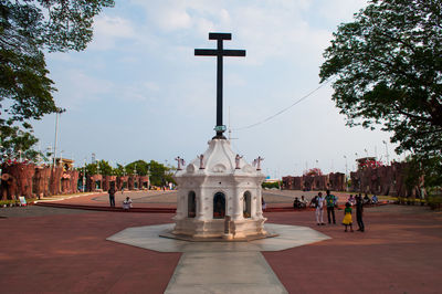 Low angle view of cross against sky