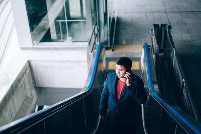 Full length of man standing on escalator