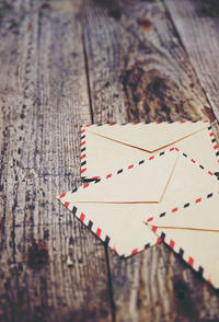 Close-up of envelopes on wooden table