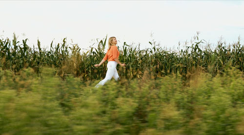 Rear view of woman standing on field