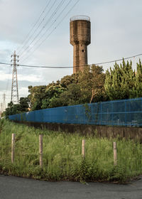 Built structure by plants against sky