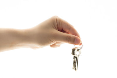 Close-up of hand holding hands over white background