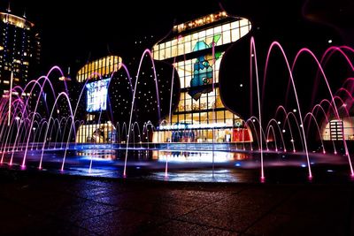 Illuminated ferris wheel at night