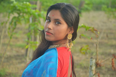 Portrait of girl wearing sari standing outdoors