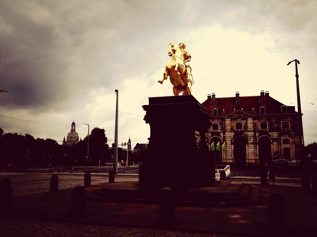 sky, statue, architecture, building exterior, built structure, sculpture, cloud - sky, human representation, art and craft, cloudy, art, cloud, street light, creativity, silhouette, animal representation, incidental people, tree, city