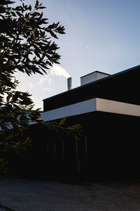 Low angle view of silhouette building against sky