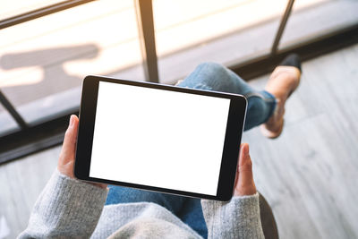 Close-up of woman using digital tablet