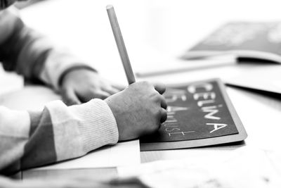 Close-up of hand using laptop on table