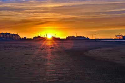 Scenic view of beach against sky during sunset