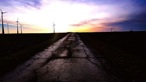 Scenic view of farm against sky during sunset