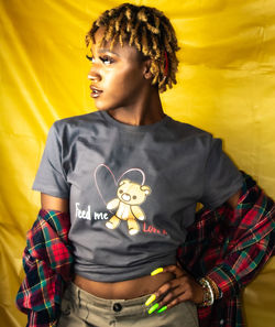 Boy standing against yellow wall