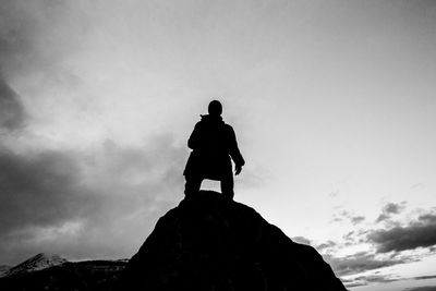 Low angle view of woman standing against sky