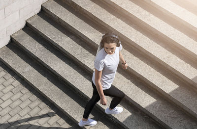 High angle view of woman sitting on staircase