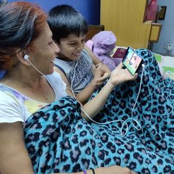 Rear view of women holding mobile phone