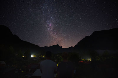 Scenic view of silhouette mountain against sky at night