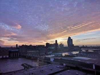 High angle view of buildings against cloudy sky during sunset